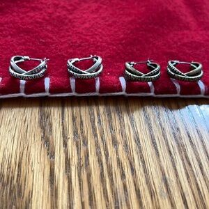 Set of silver and antique gold colored earrings.